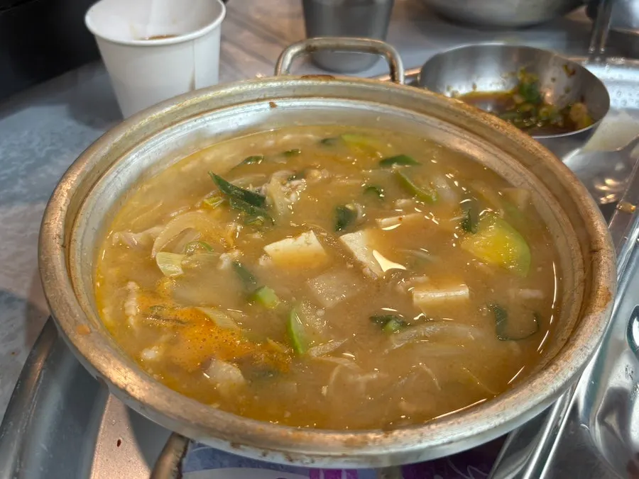 Light-colored doenjang jjigae and rice at Smile Hall