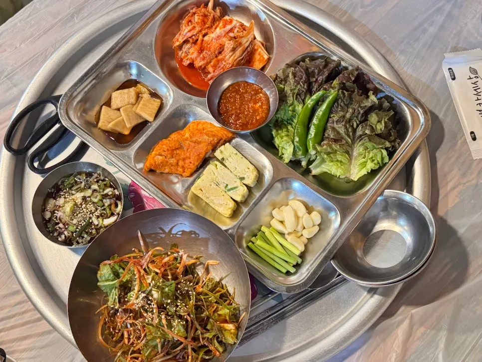 Retro-style banchan spread served on a metal tray