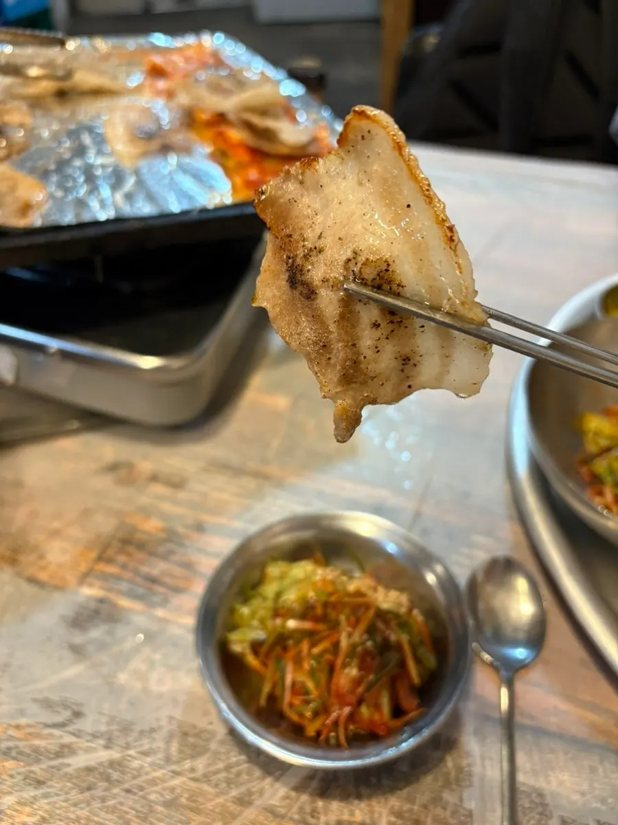 Grilled kimchi placed alongside the meat