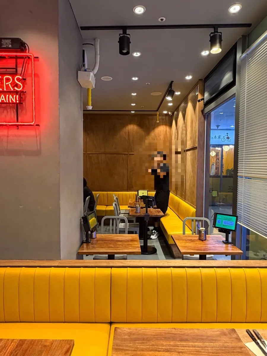 Sofa seating with mustard-colored and wood-tone interior