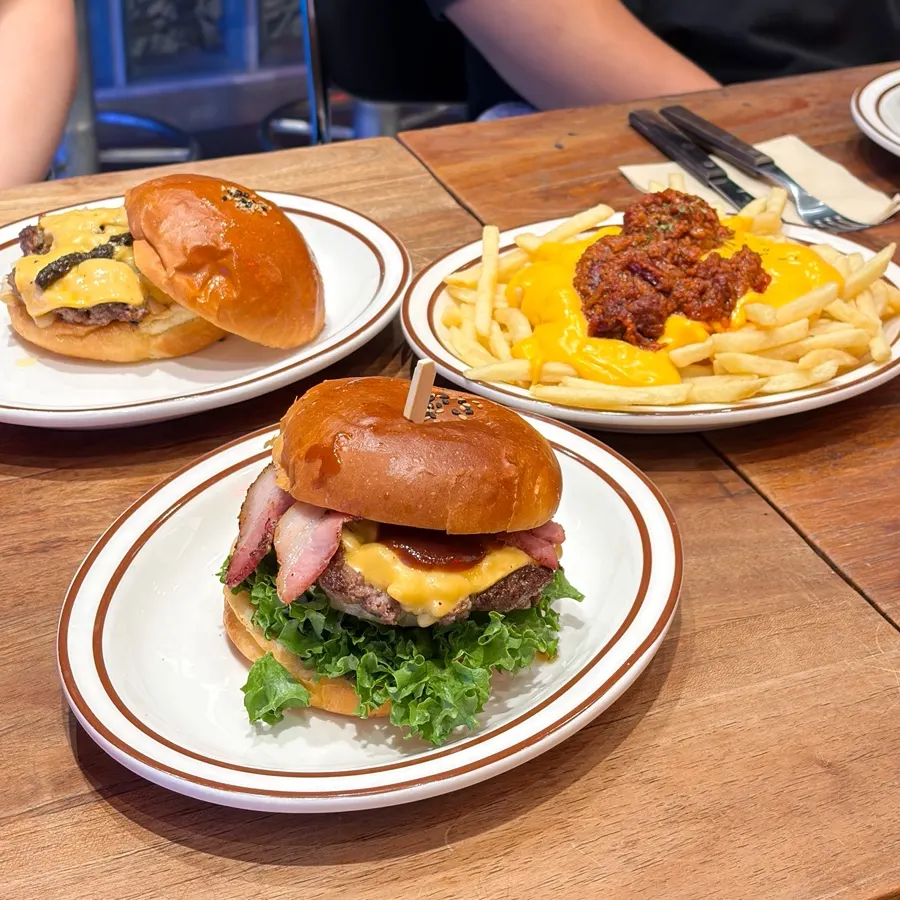 Burgers and side dishes lined up at Daily Fix