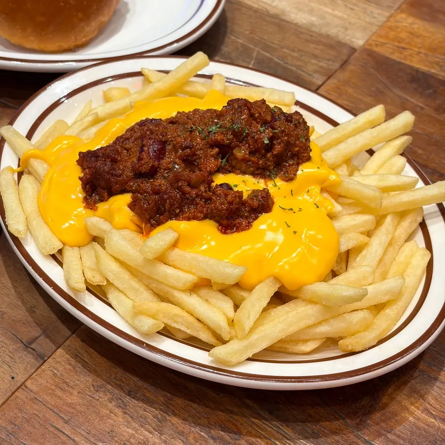 Chili cheese fries topped with melted cheddar cheese