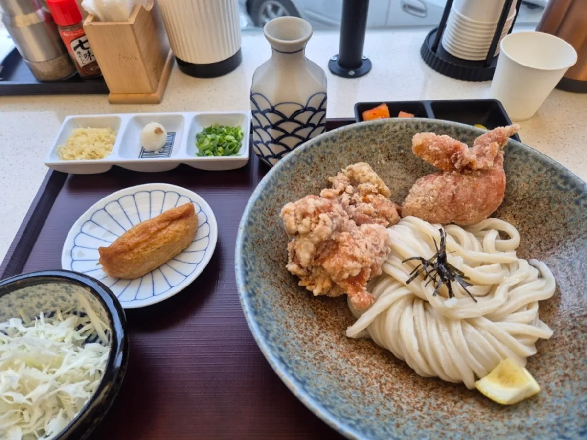 Toritenbukkake udon topped with fried chicken thigh