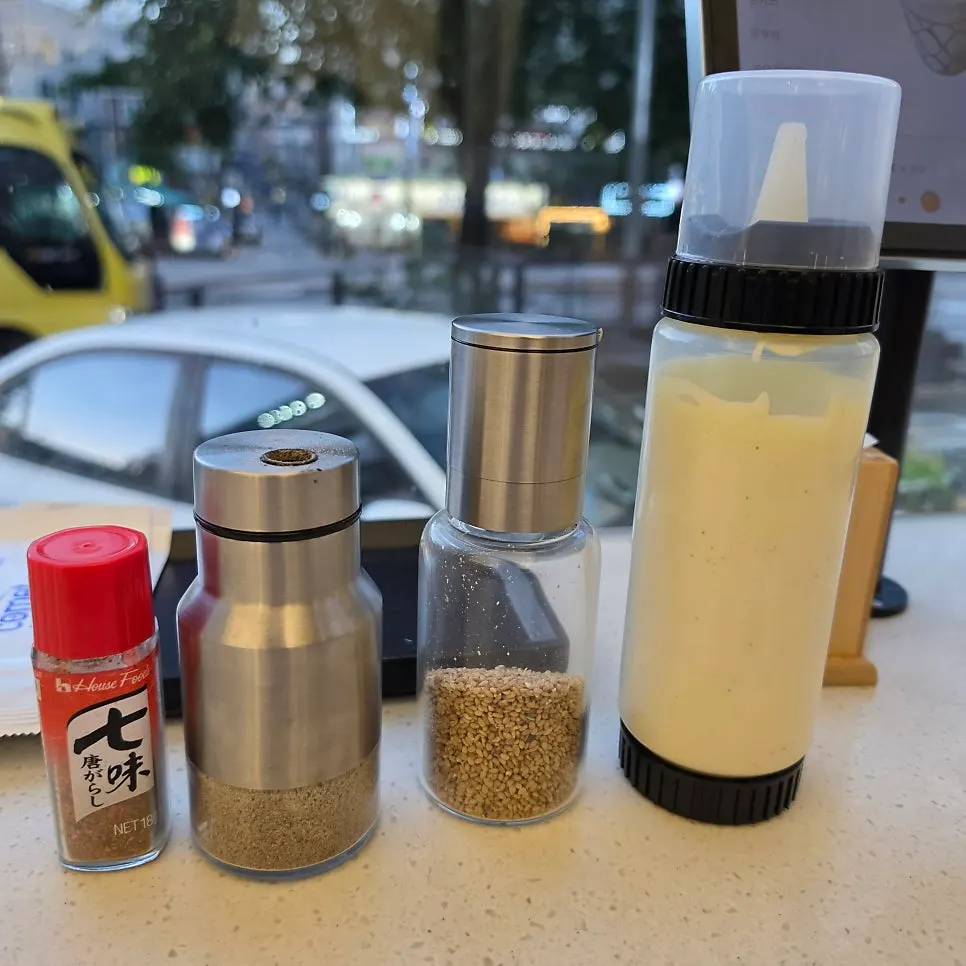 Utensils, seasonings, and sauces set at each table