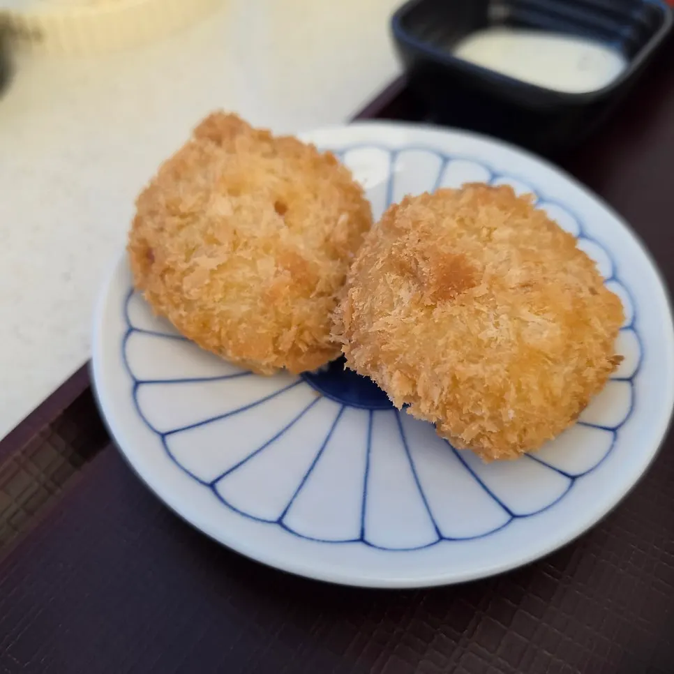 Two pieces of crispy fried sweet potato korokke