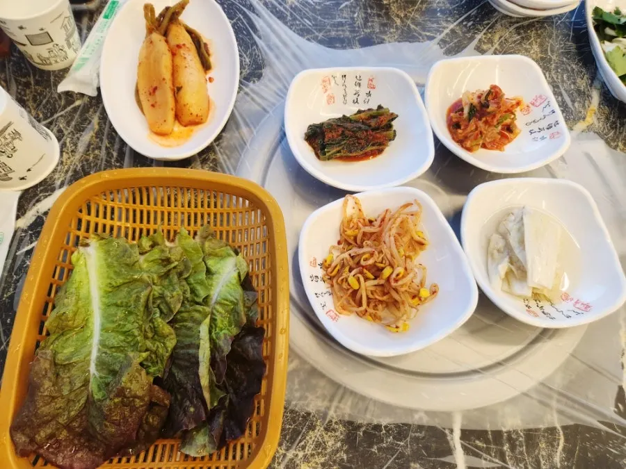 Table setting with gat kimchi, chonggak mu kimchi, and other basic side dishes