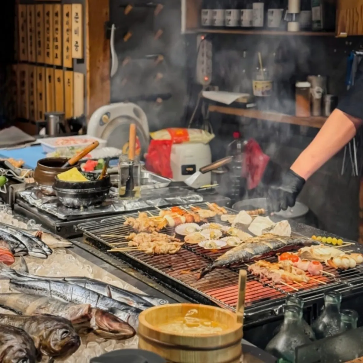 Skewers being grilled at the open charcoal grill