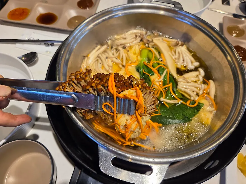 Cooking ingredients in boiling broth