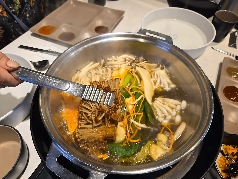 Plate of cooked meat and vegetables scooped out of the broth