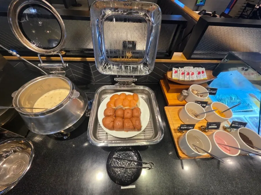 Self-serve bar with rice cakes, dumplings, sujebi, and glass noodles