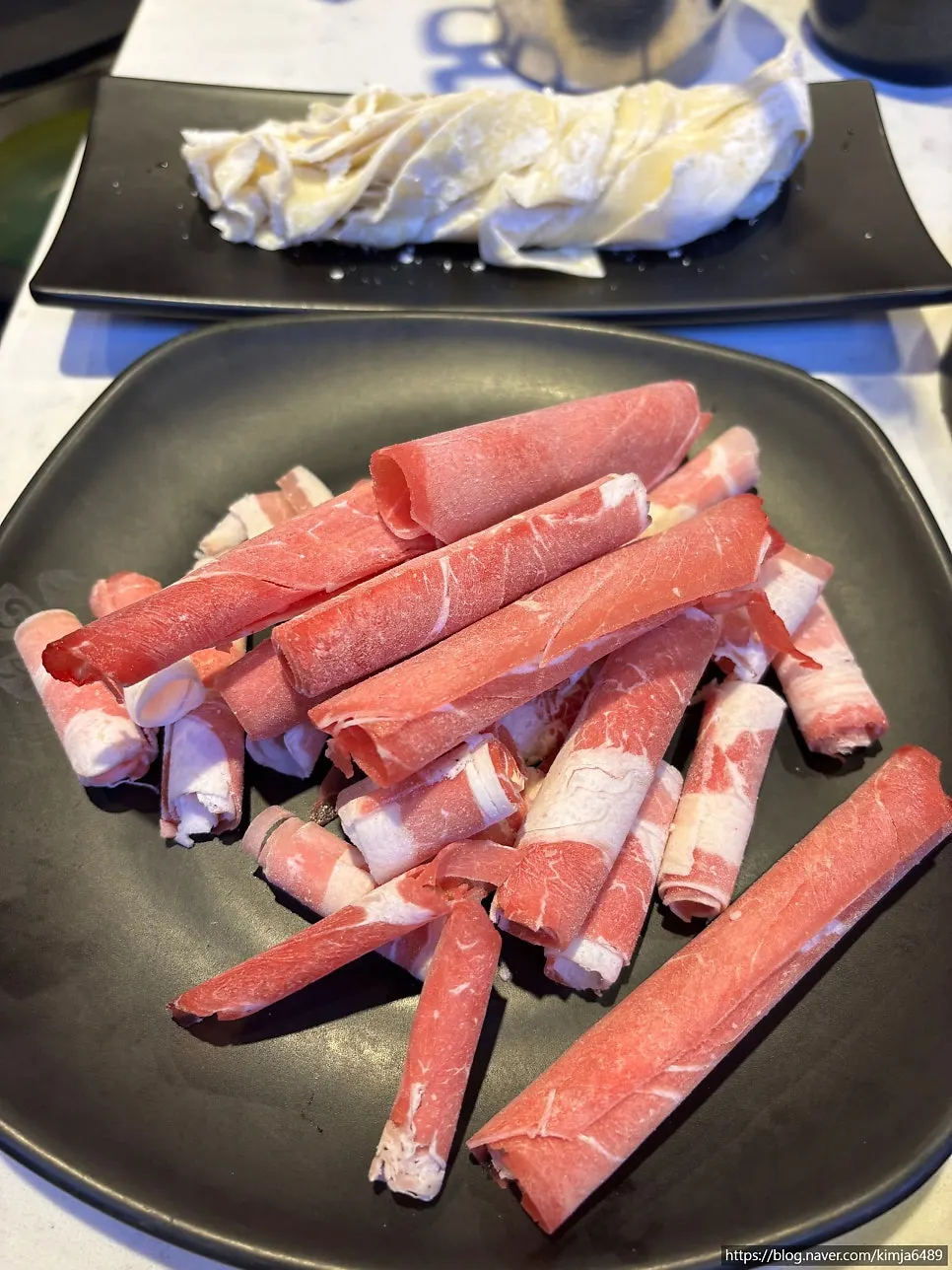 Spicy shabu-shabu broth topped generously with minari