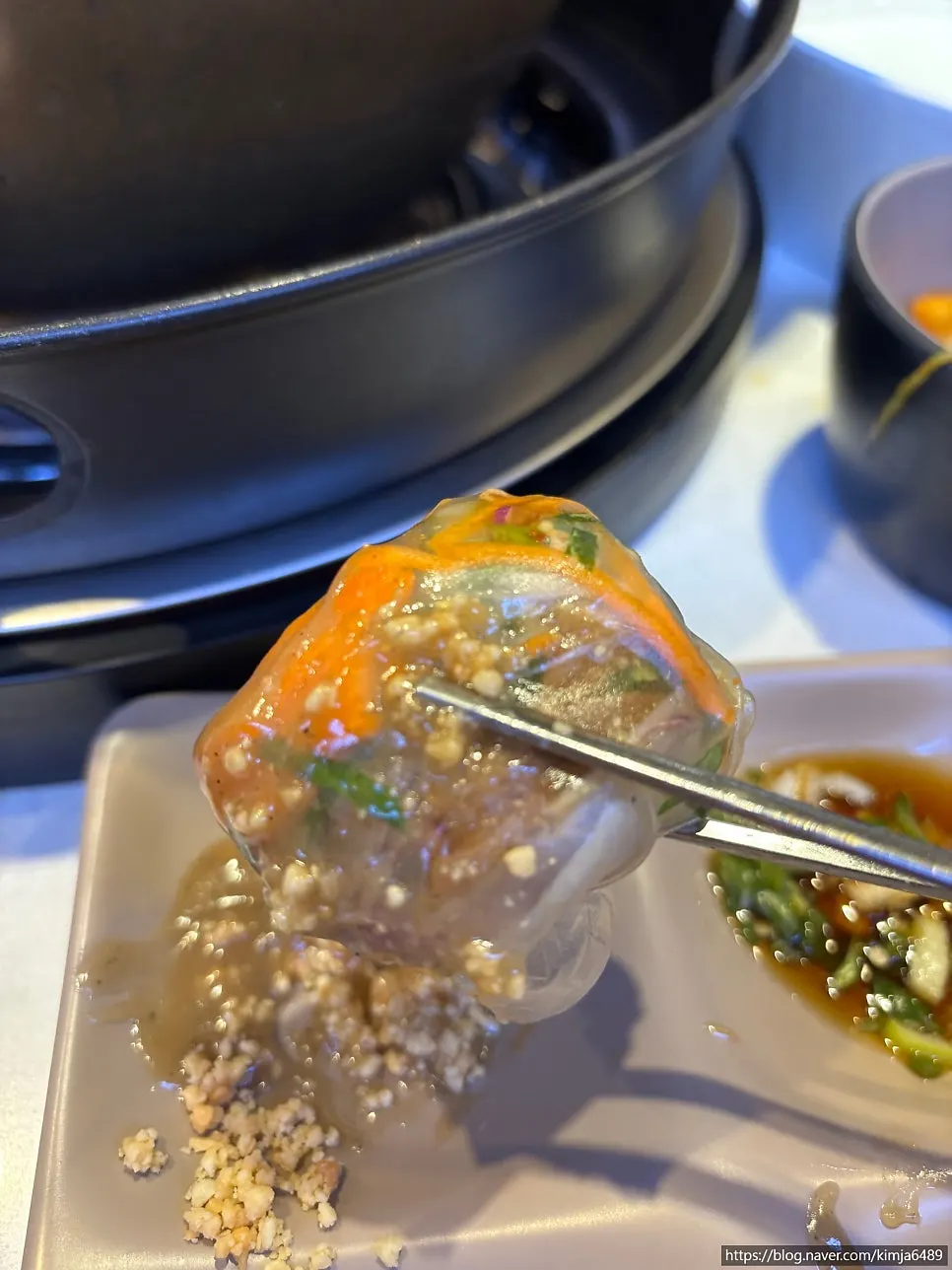 A bite of spring roll with sauce