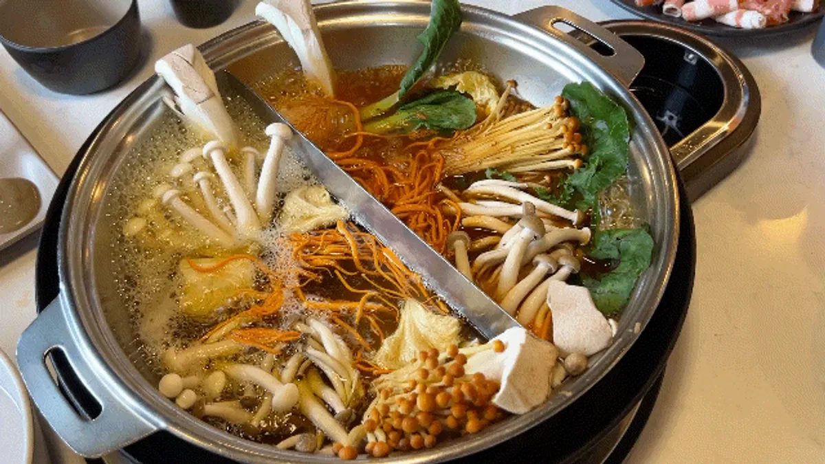 Mushrooms simmering in the broth for mushroom shabu