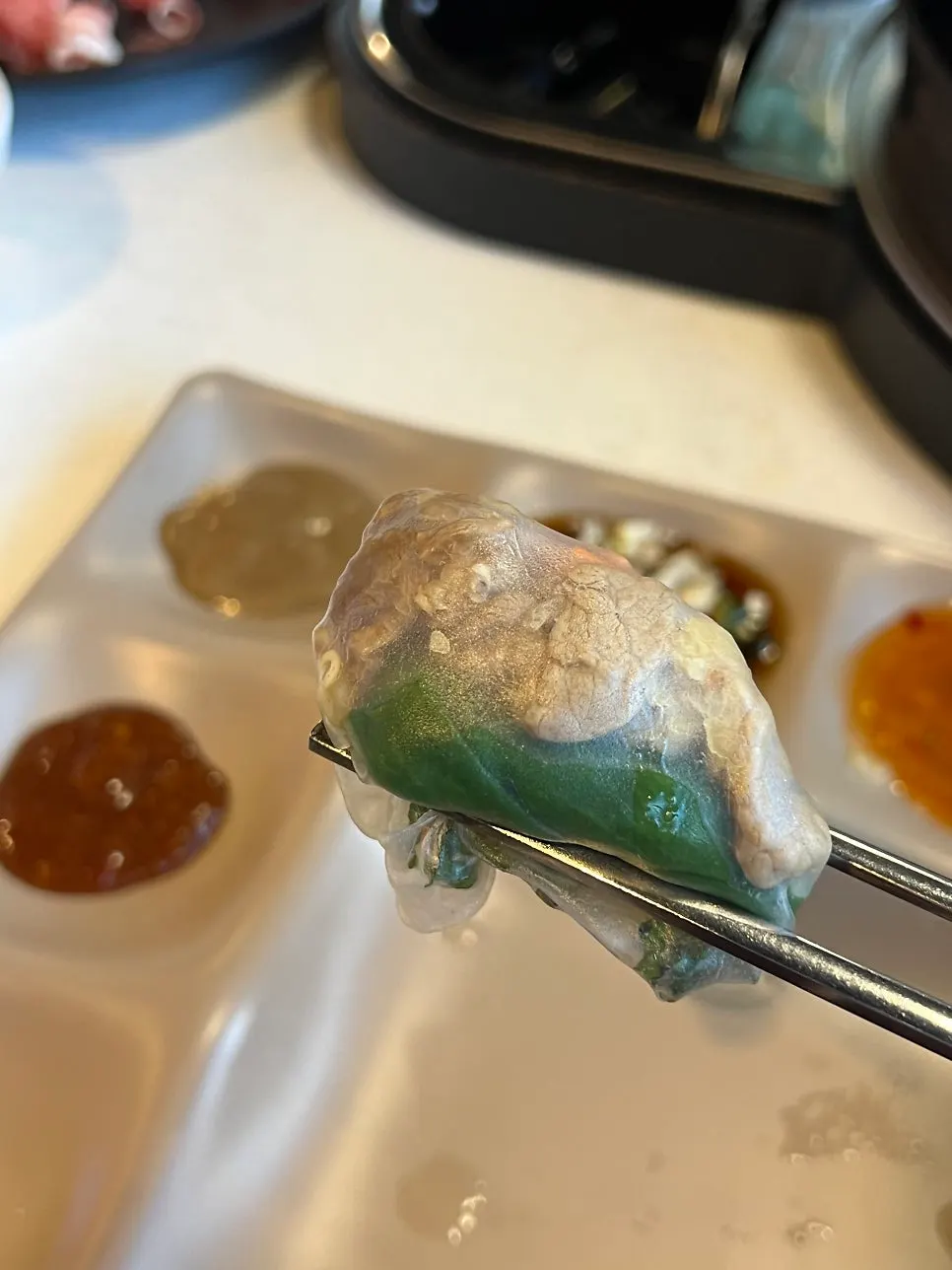 A spring roll wrapped with meat and vegetables in rice paper