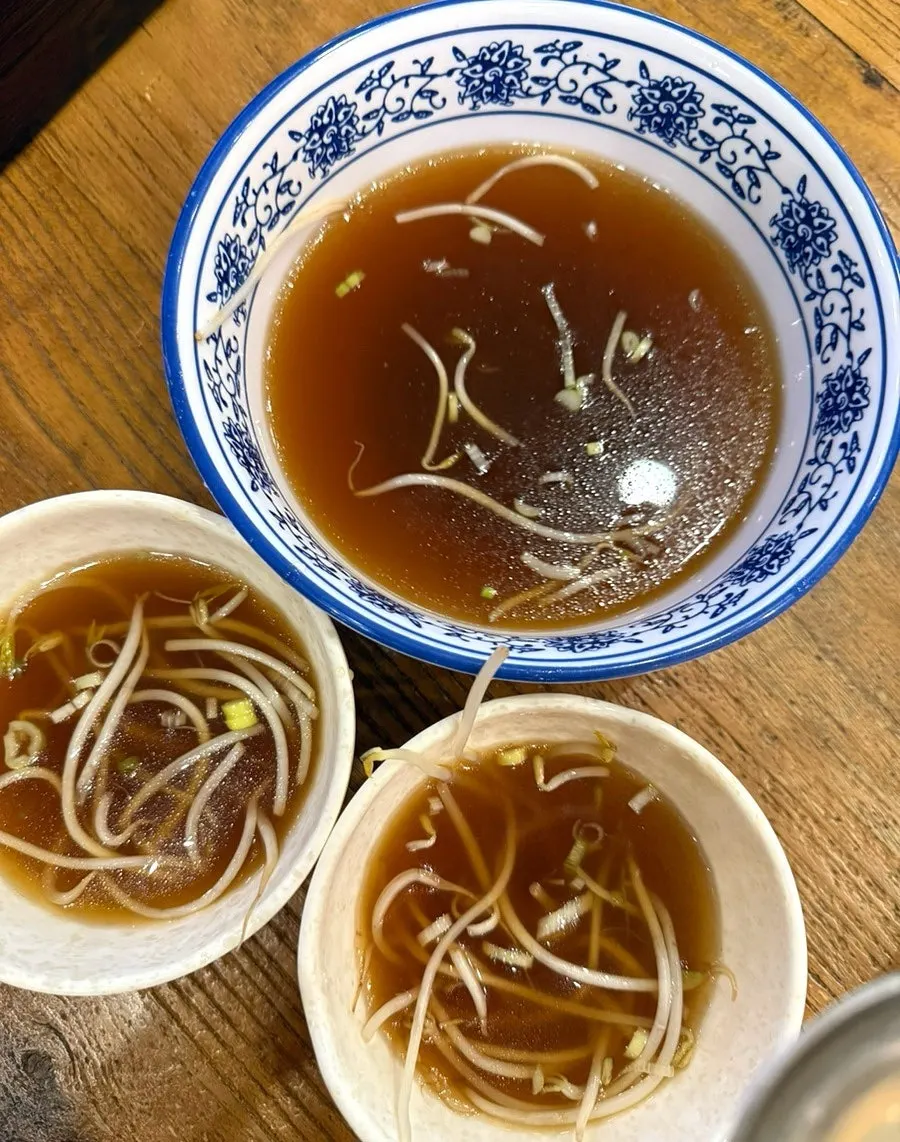 The complimentary pho broth served as a side