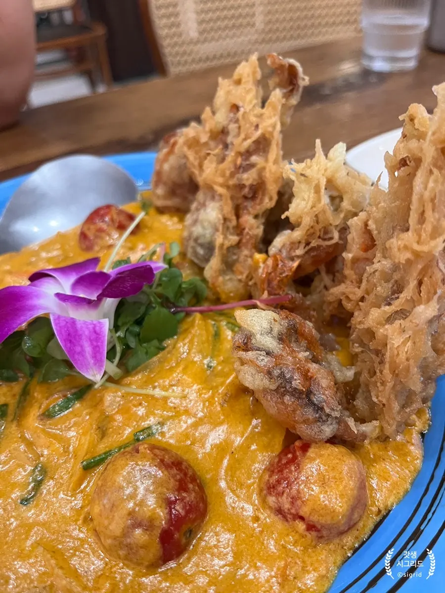 Close-up of poo pad pong curry topped with soft-shell crab