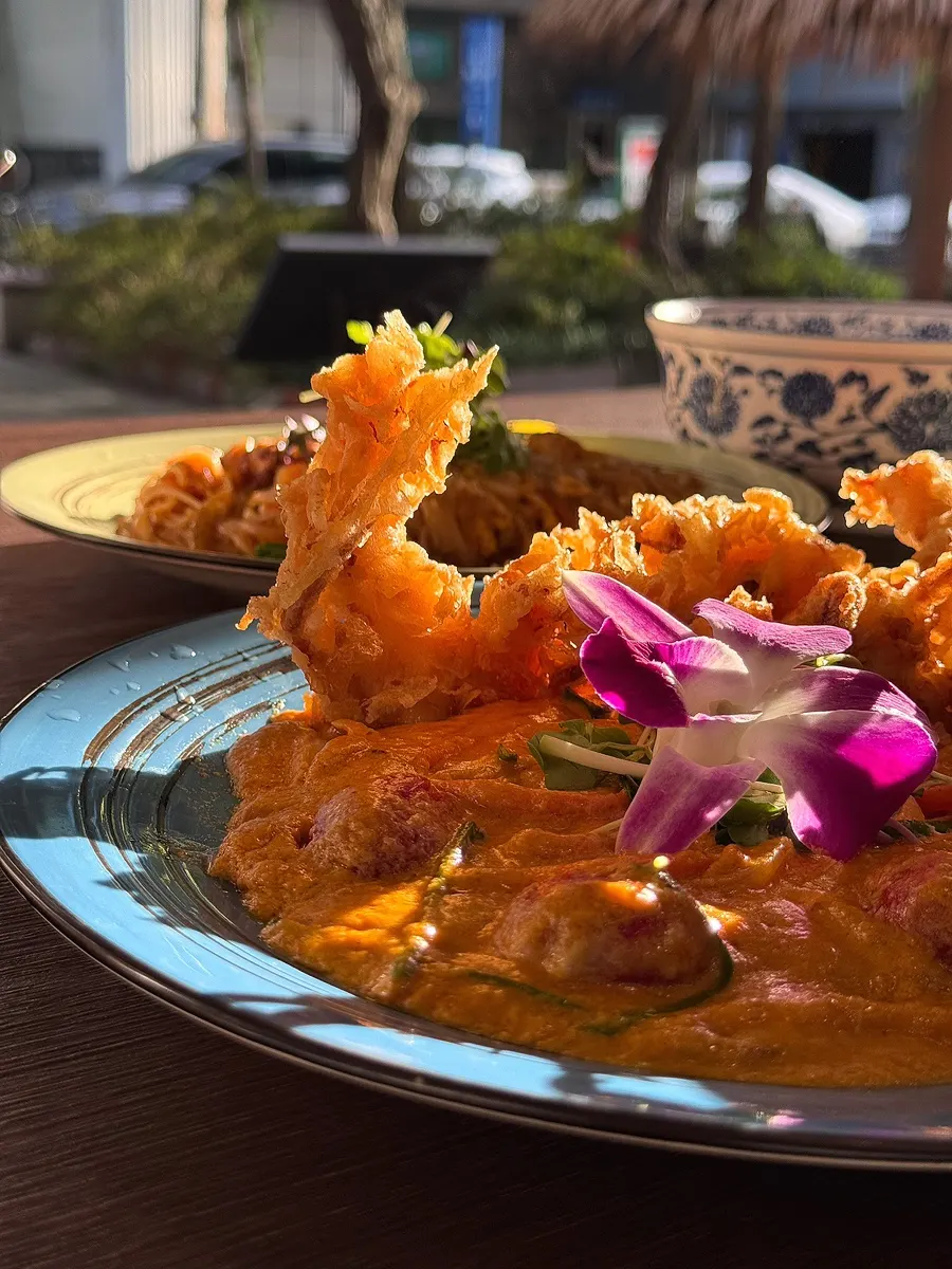 Poo pad pong curry topped with soft-shell crab tempura