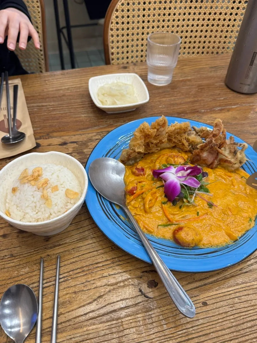 Pu pad pong curry topped with fried soft-shell crab