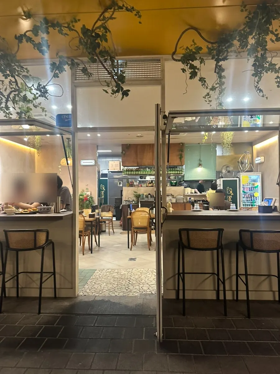 Entrance of Soi Nana Seongsu with customers coming and going on a weekday evening