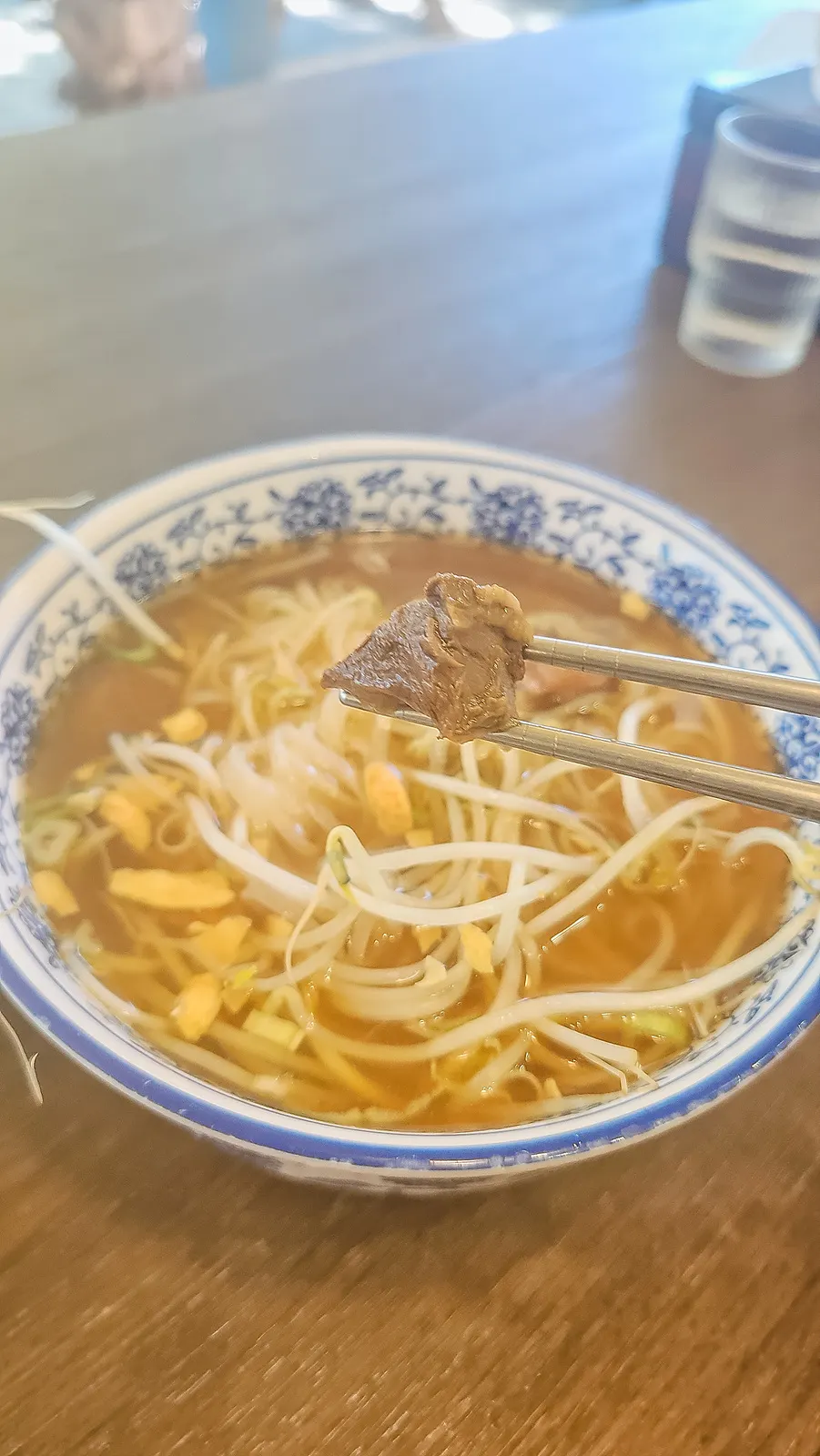 Tender braised beef shank lifted with chopsticks