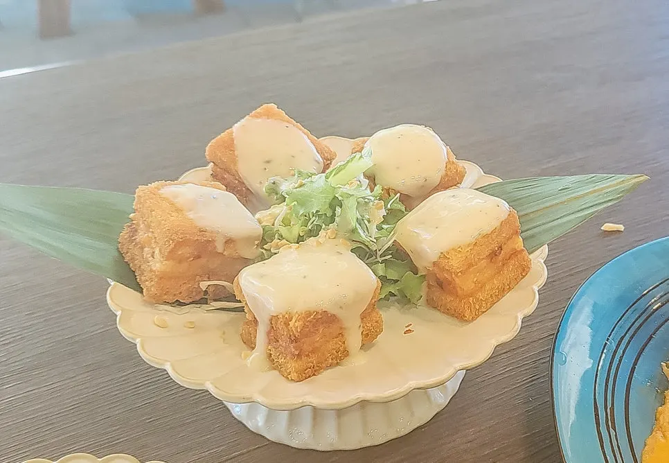 Cross-section of menbosha with sweet-tangy lemon cream sauce