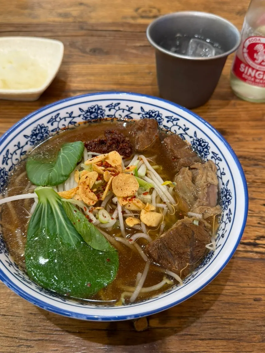 A bowl of pho with extra coriander