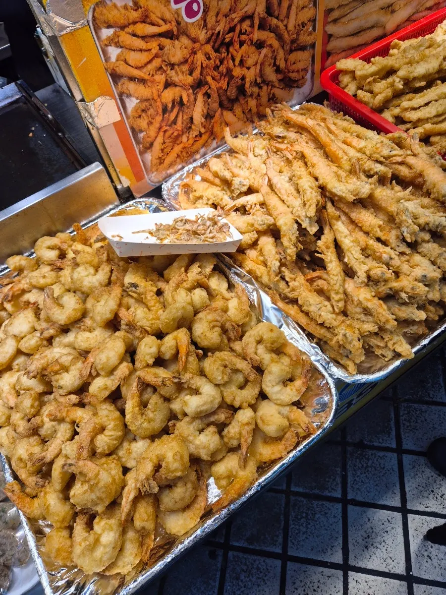 Displayed fried snacks and menu options at Hwangbuja Twigim