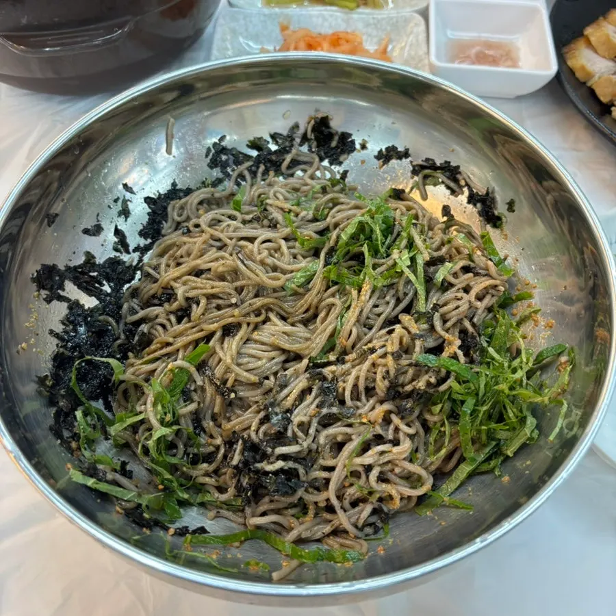 Perilla oil buckwheat makguksu with shredded seaweed and sesame seeds
