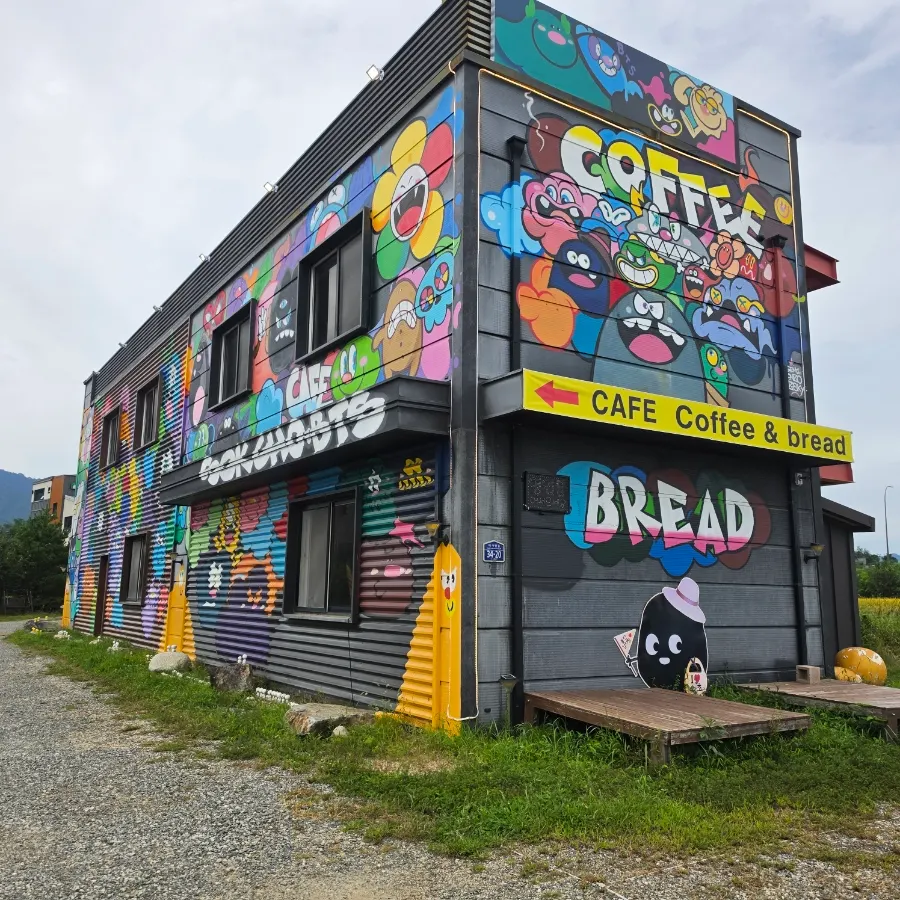 Exterior of Sokcho Bultan Gamja Bread Main Store decorated with colorful characters