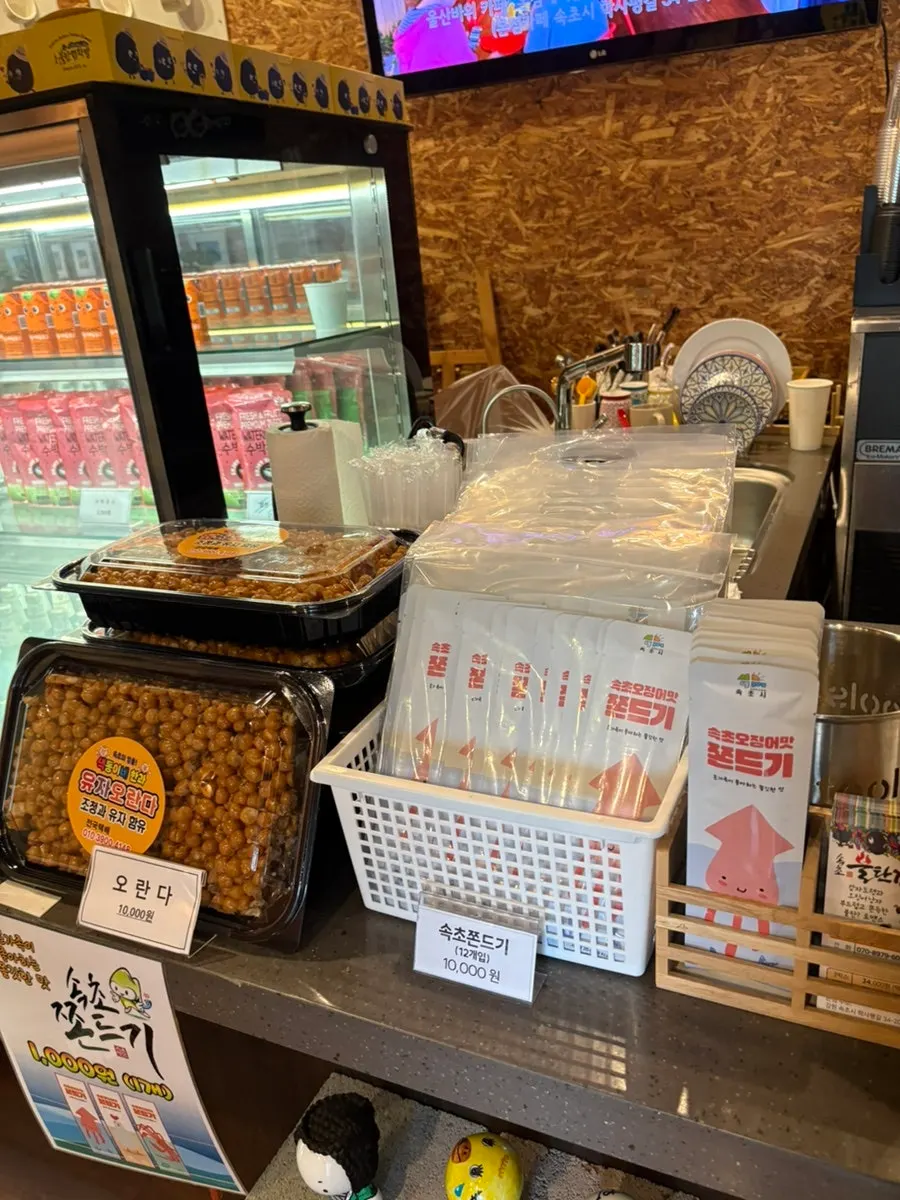 Menu board listing prices for potato bread and jjondeugi