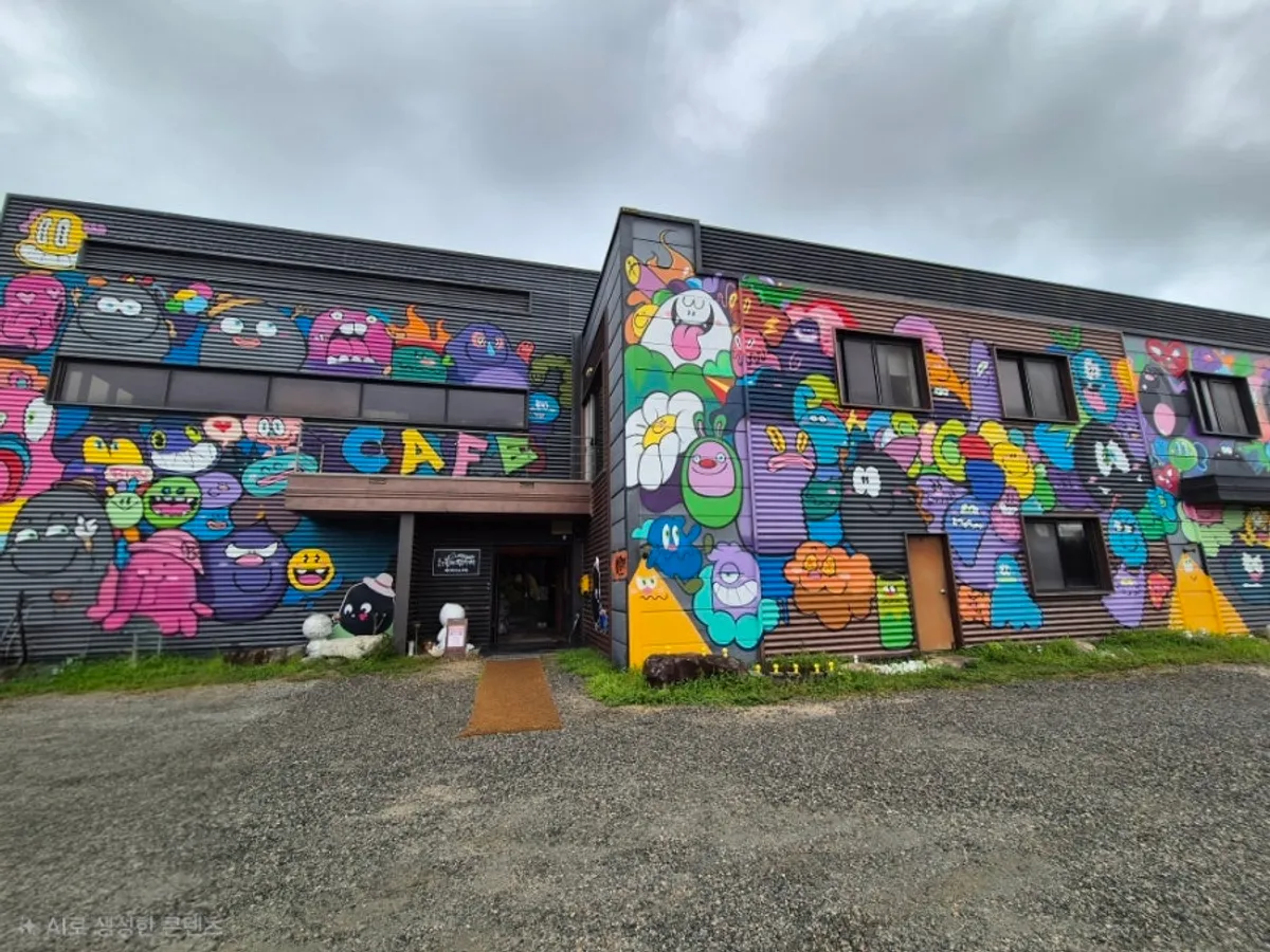 Large parking lot in front of the store with graffiti exterior