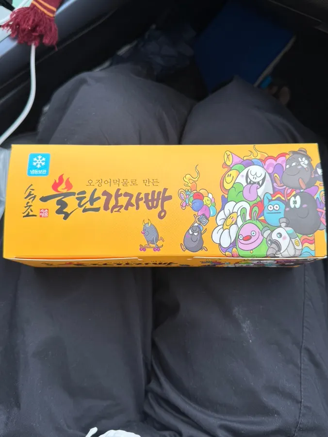 Takeout boxes of bultan gamja bread and Sokcho jjondeugi