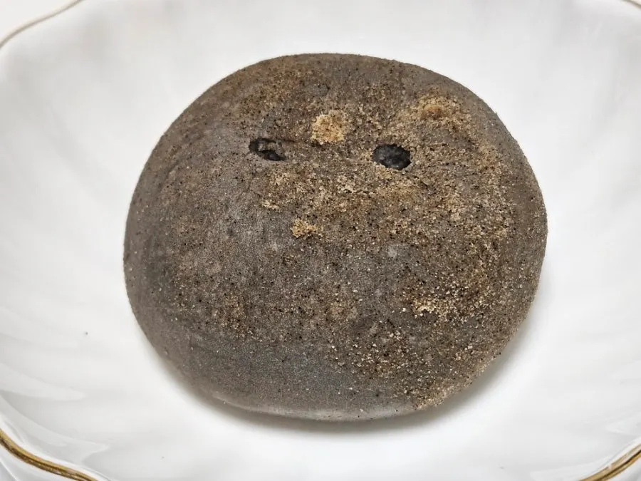 Bite taken out of the black potato bread