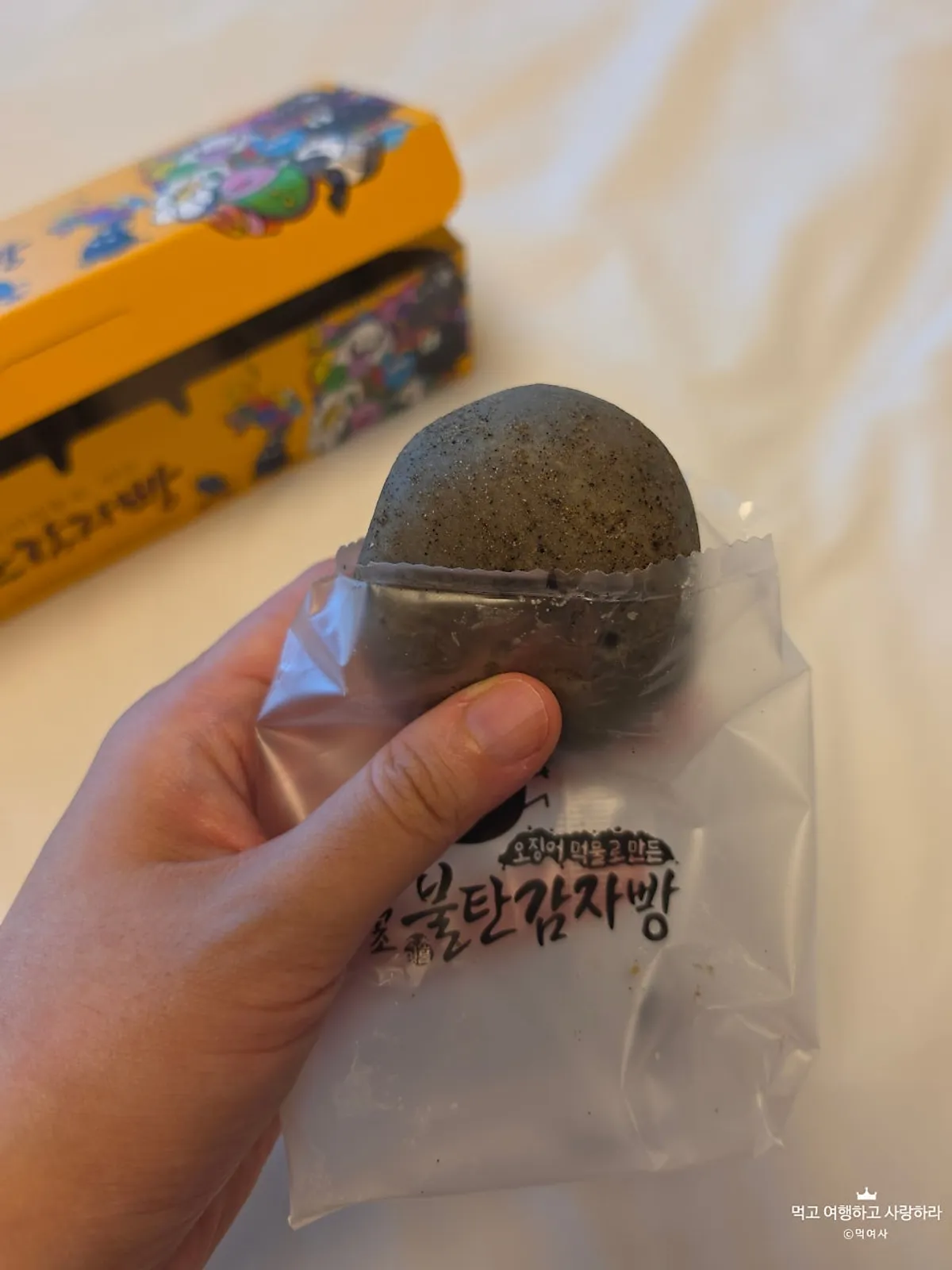Holding a single Sokcho Bultan Gamja Bread