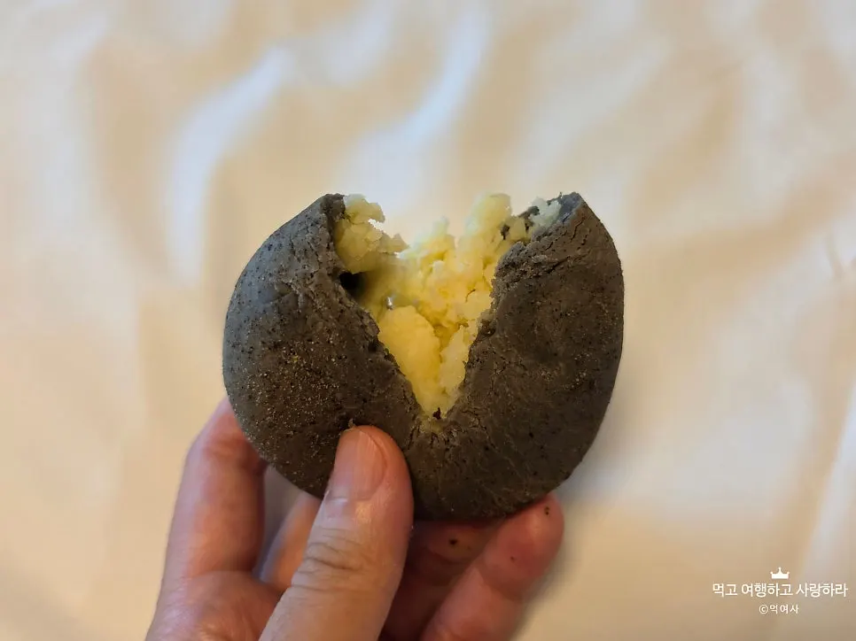 Potato bread cut in half revealing yellow potato filling