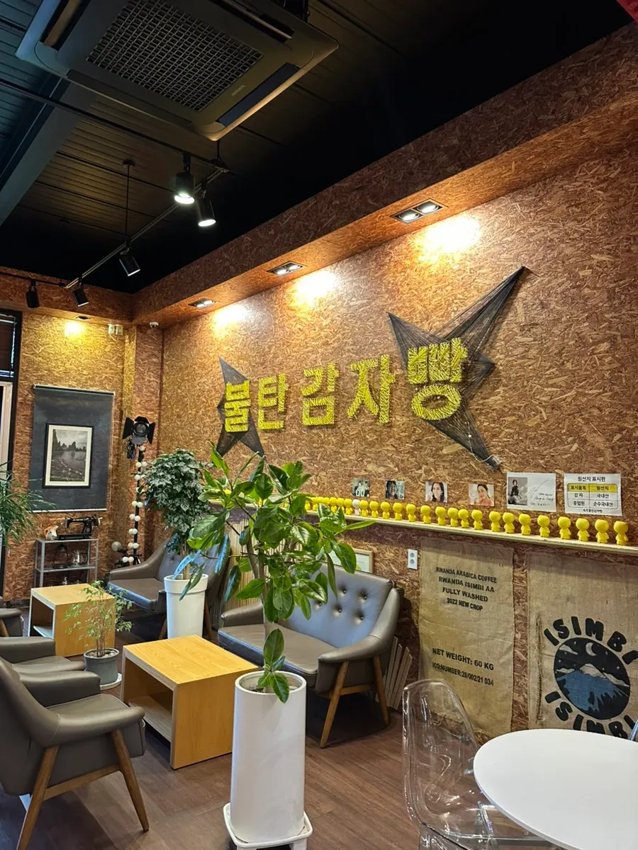 Exterior of Sokcho Bultan Gamja Bread Main Store with character illustrations