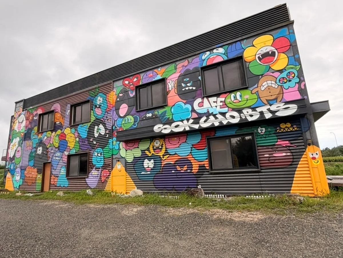 Exterior of Sokcho Bultan Gamja Bread Main Store decorated with character graffiti