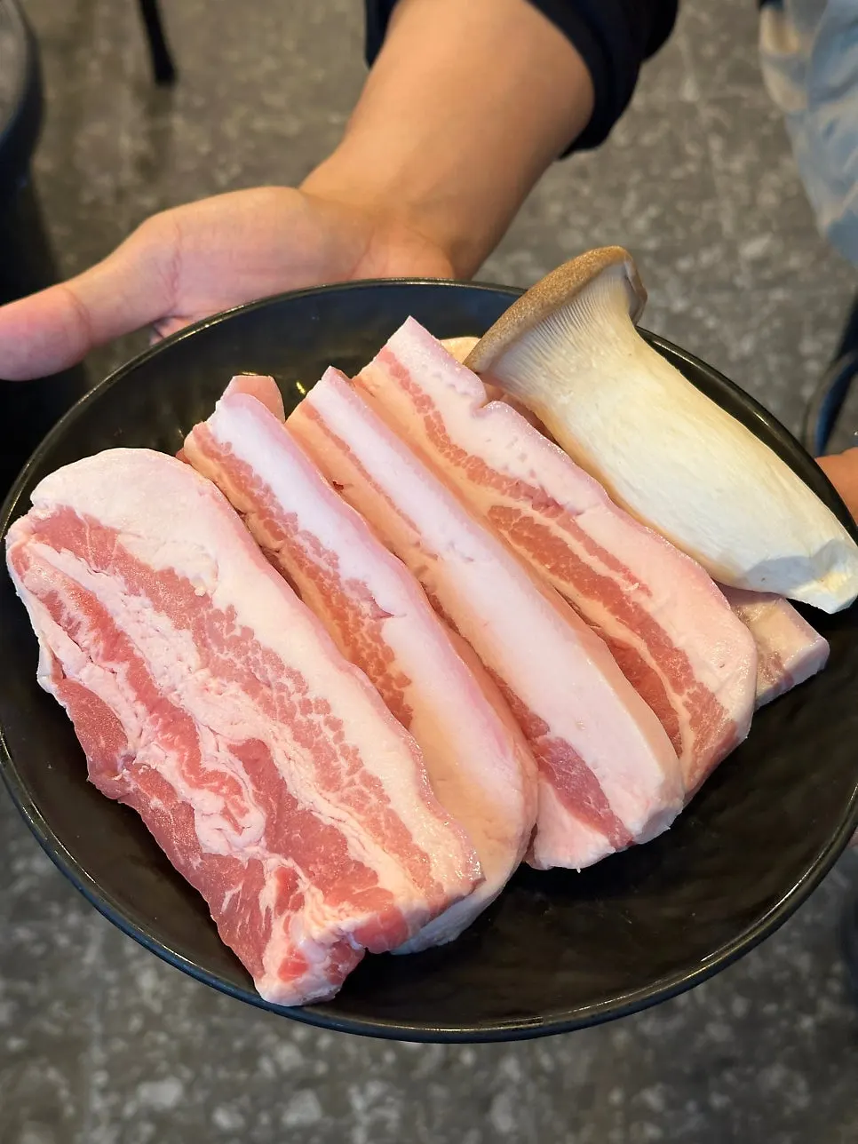 Three servings of pork belly on a plate