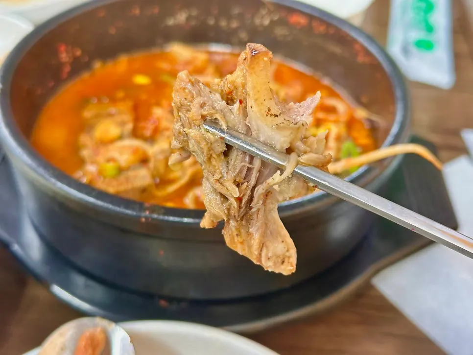Meat picked off the bone alongside the broth