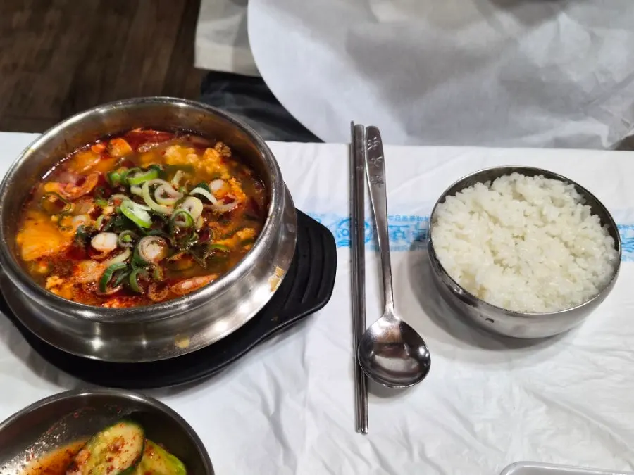 A bowl of spicy sundubu with sharp, savory broth