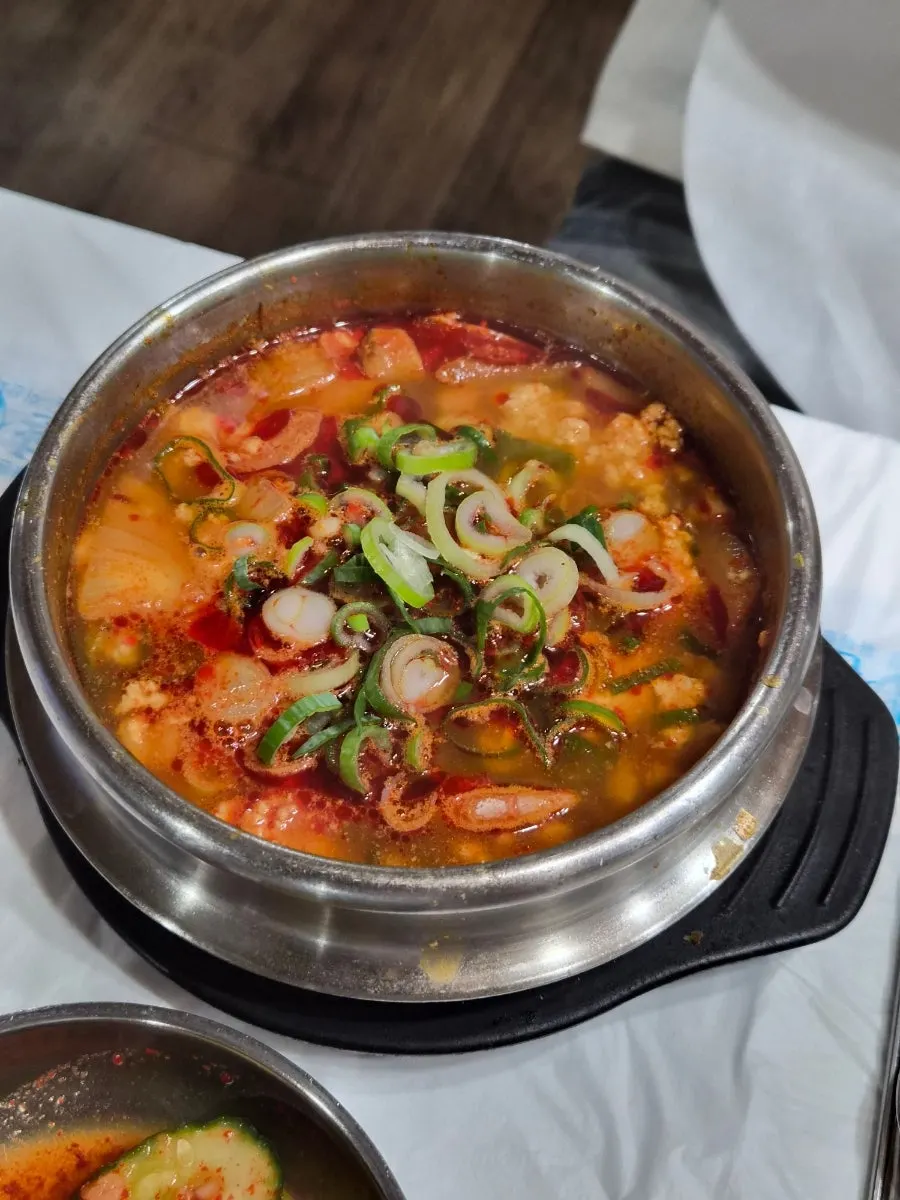 Close-up of the spicy sundubu broth and ingredients