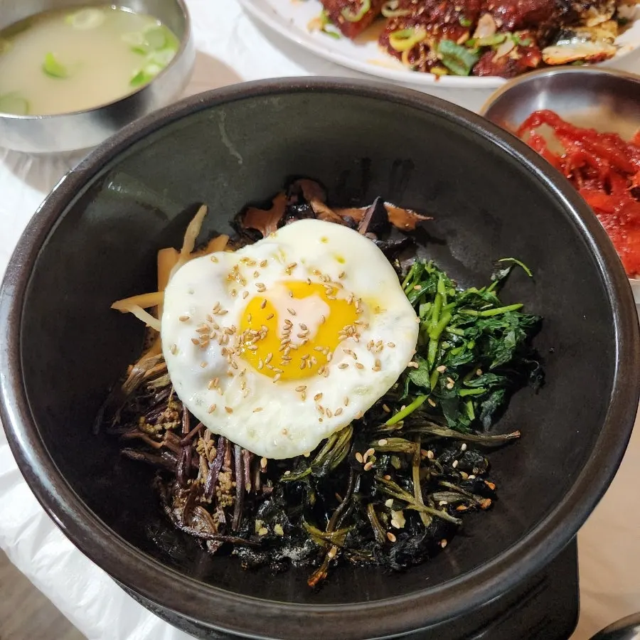 Wild greens bibimbap topped with a fried egg