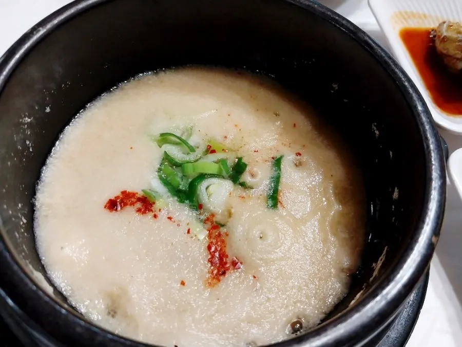 House-made kimchi and buji jjigae side dish spread