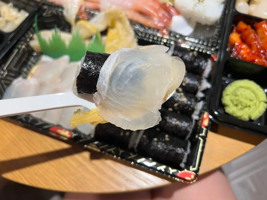 Picking up a piece of sweet shrimp sashimi