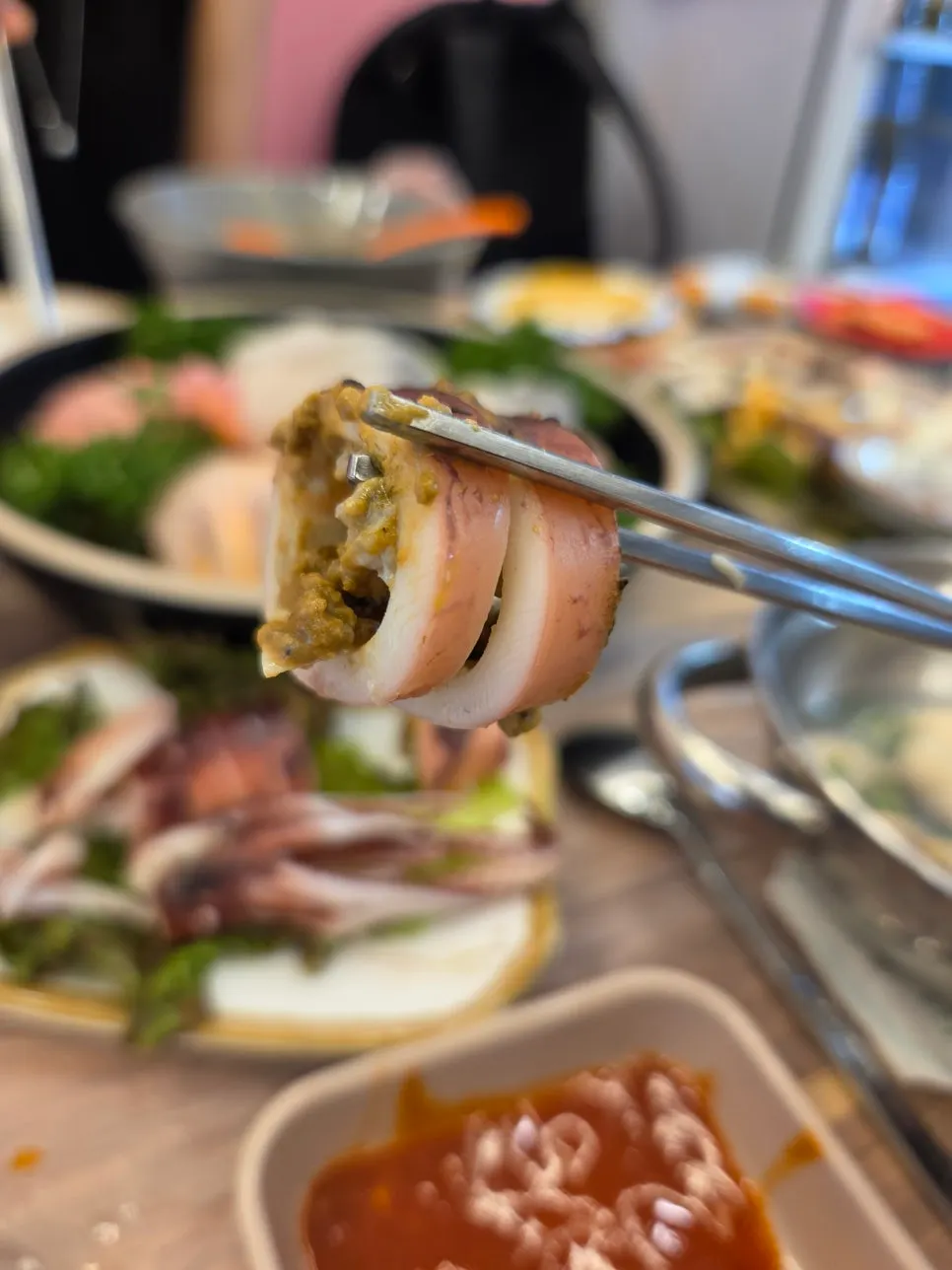Sliced steamed squid meat served to the table