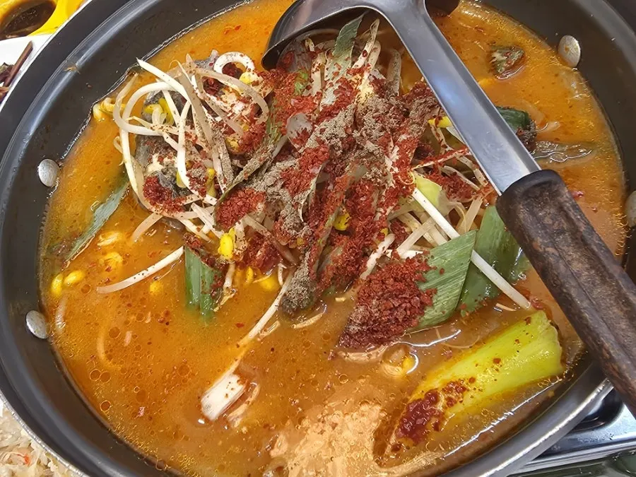 Pot of spicy fish stew served as the final course