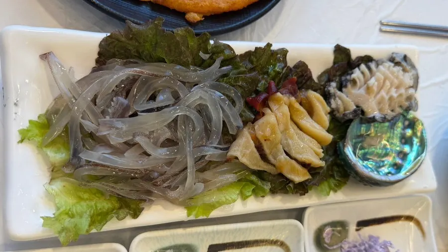 Plate of squid sashimi, abalone sashimi, and sea cucumber