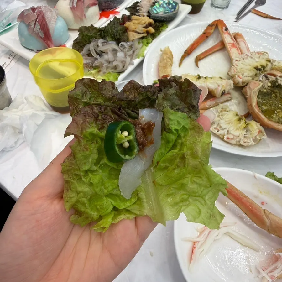 Chopsticks picking up a piece of sashimi