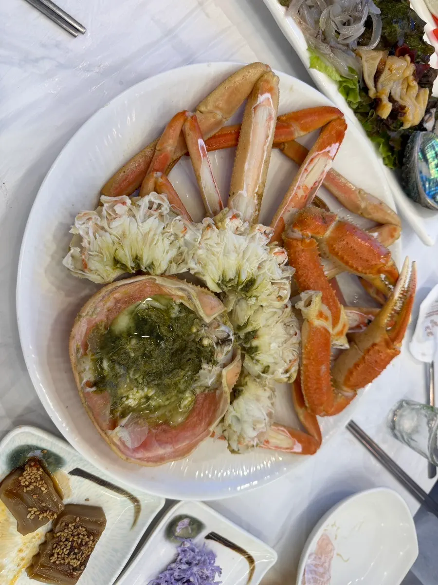 Table spread of pre-cleaned steamed snow crab