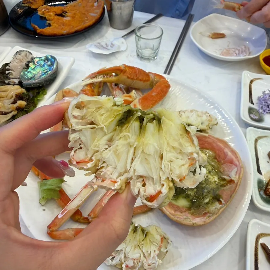 Crab meat dipped into the shell's innards